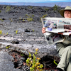 Keith Anderson pauses on the Kilauea Caldera to catch up on the news from home while visiting the Volcanoes National Park on the island of Hawaii.