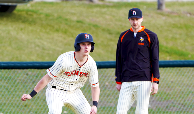 Ethan Sjostrom on third base, with Pelican baseball coach Andy Johnson.